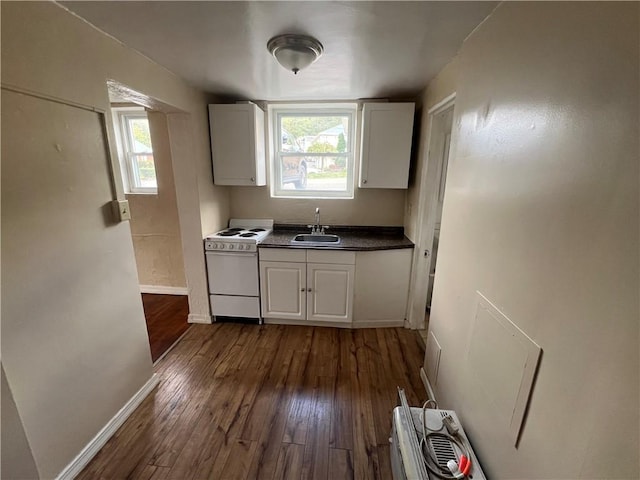 kitchen with white cabinetry, a healthy amount of sunlight, white electric range oven, and sink