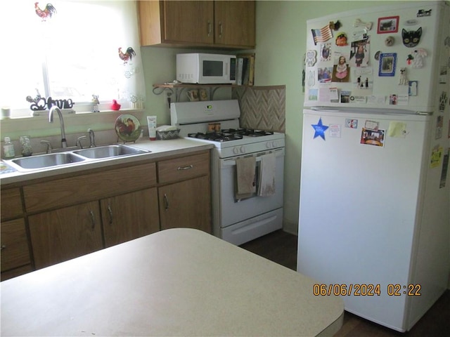 kitchen with sink and white appliances