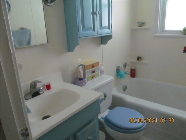 full bathroom featuring toilet, vanity, and bathtub / shower combination