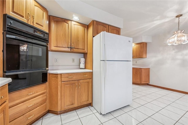 kitchen with white fridge, light tile patterned floors, black double oven, and decorative light fixtures