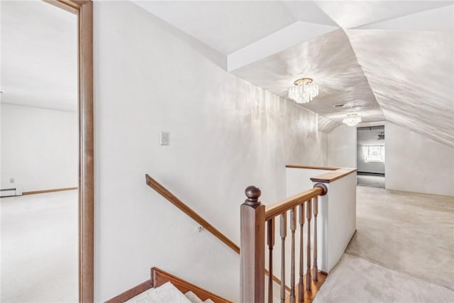 stairway with carpet floors, lofted ceiling, and a chandelier