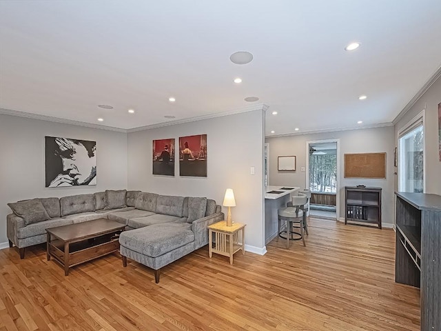 living room featuring light hardwood / wood-style flooring and ornamental molding