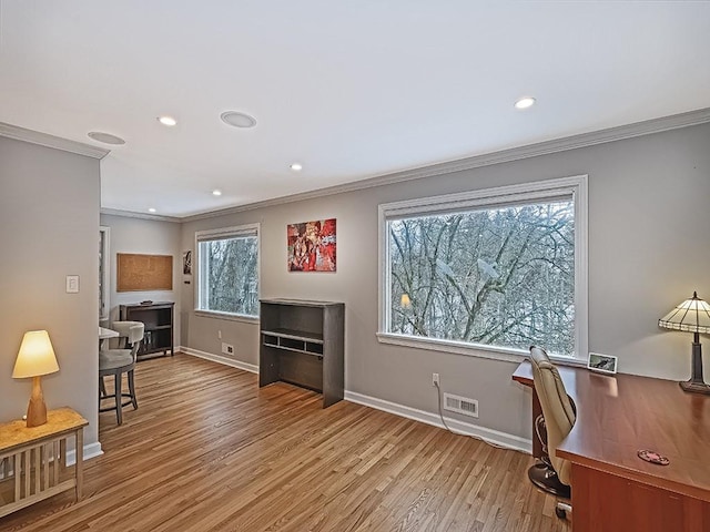 office featuring light hardwood / wood-style flooring and crown molding