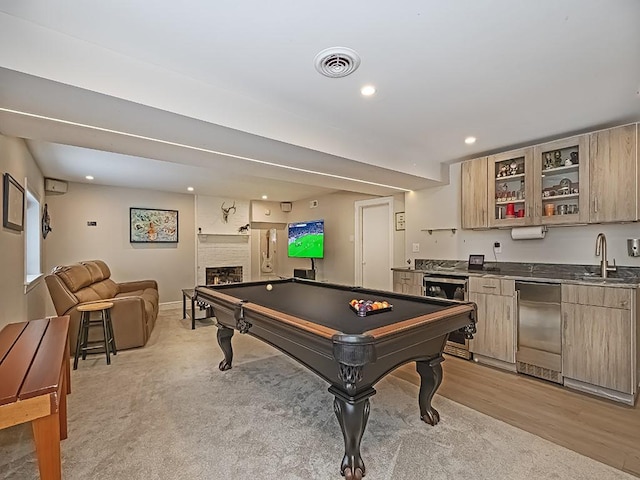 rec room with wine cooler, light colored carpet, a fireplace, indoor wet bar, and pool table