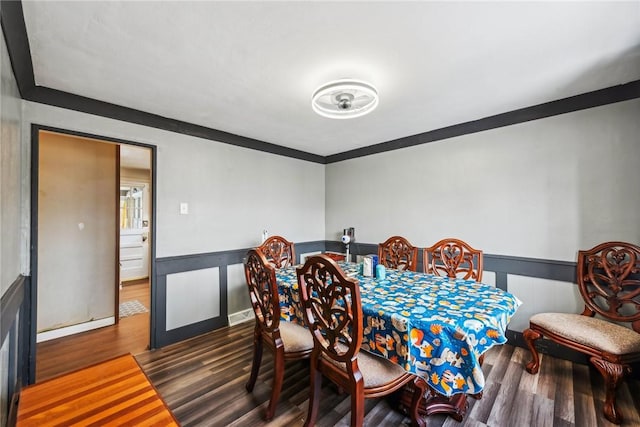 dining area featuring dark hardwood / wood-style flooring and ornamental molding