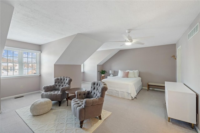 bedroom with ceiling fan, light carpet, vaulted ceiling, and a textured ceiling