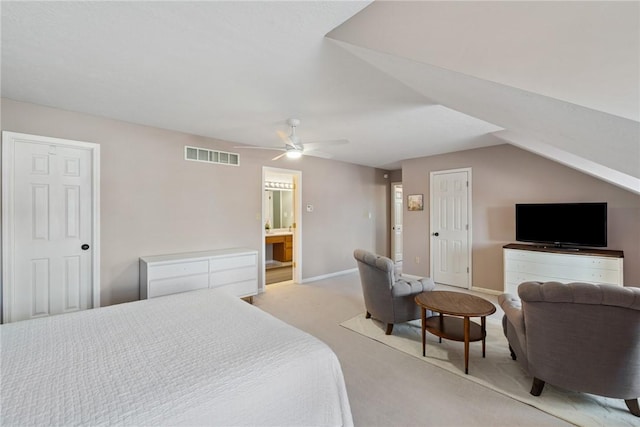 carpeted bedroom featuring ceiling fan, vaulted ceiling, and connected bathroom