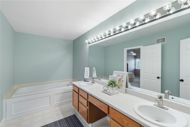 bathroom with ceiling fan, a tub, and vanity