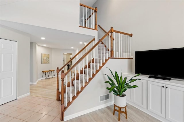 staircase featuring tile patterned flooring