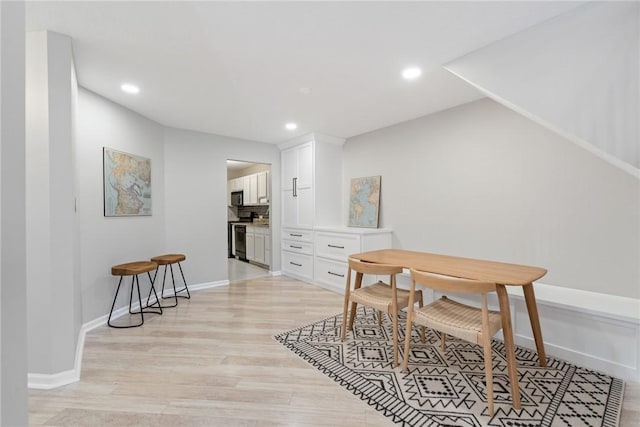 dining space with light wood-type flooring