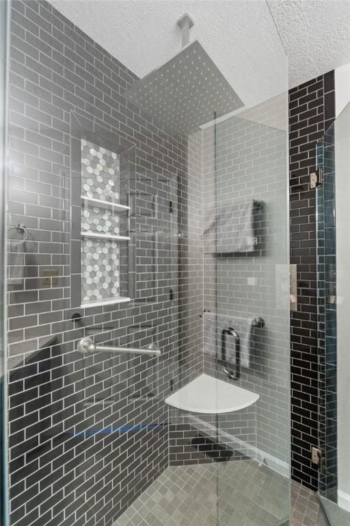 bathroom with a textured ceiling and walk in shower