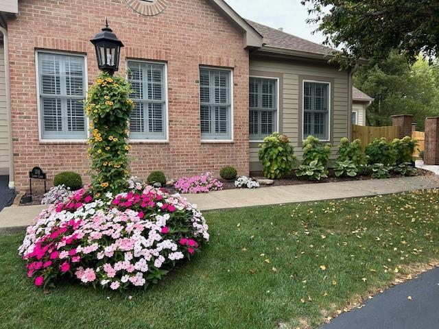 view of side of property with a yard