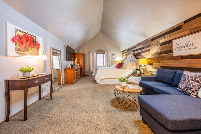 bedroom with vaulted ceiling, light colored carpet, and wooden walls