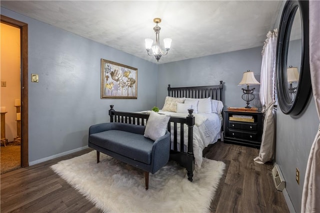 bedroom featuring dark hardwood / wood-style floors and an inviting chandelier