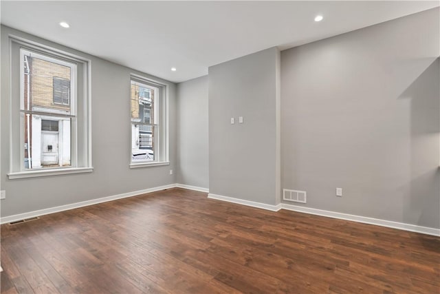 unfurnished room with dark hardwood / wood-style flooring