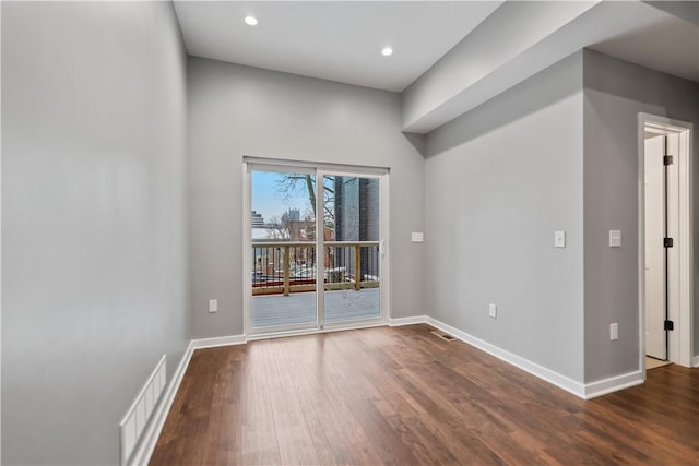 empty room with dark hardwood / wood-style flooring