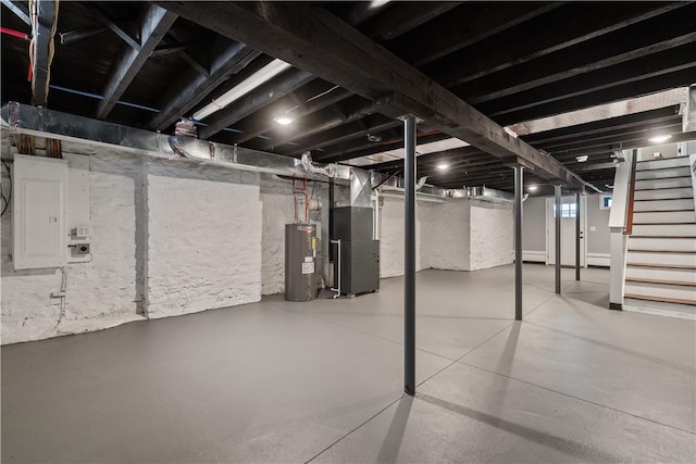 basement featuring electric water heater, heating unit, and electric panel