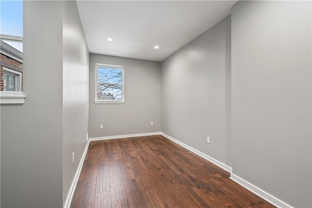 spare room with dark wood-type flooring