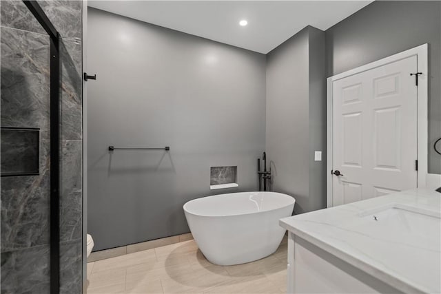 bathroom with vanity and a washtub