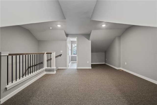 bonus room with carpet and vaulted ceiling