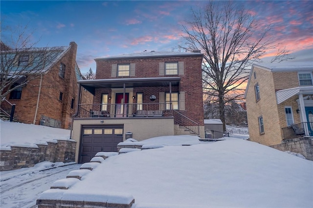 view of front of house featuring a porch and a garage