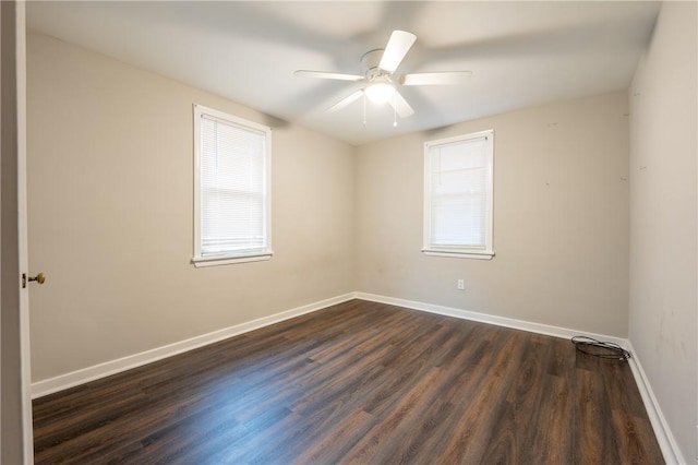 empty room featuring ceiling fan and dark hardwood / wood-style floors