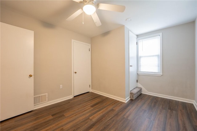 interior space featuring ceiling fan and dark hardwood / wood-style floors