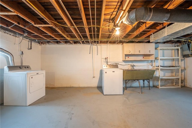 basement with washing machine and dryer and sink