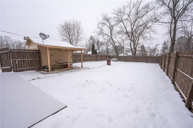 view of yard layered in snow