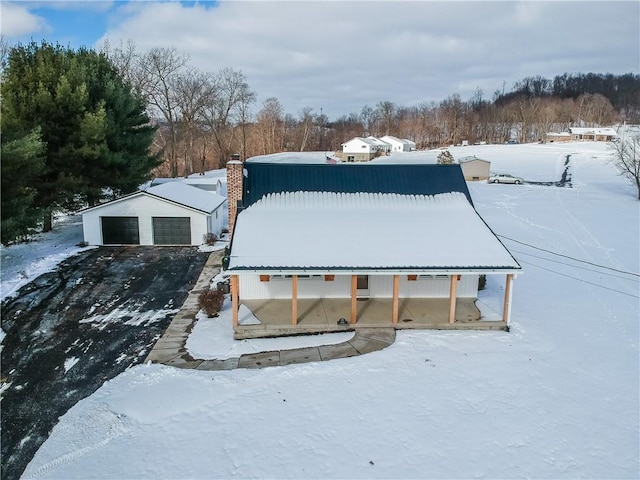 exterior space featuring a garage and an outbuilding