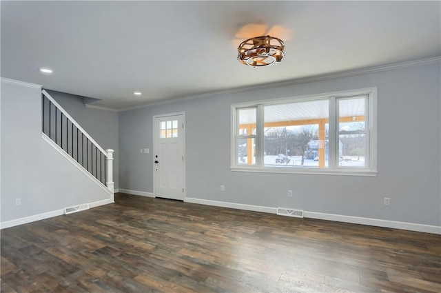 foyer entrance with dark hardwood / wood-style flooring and crown molding