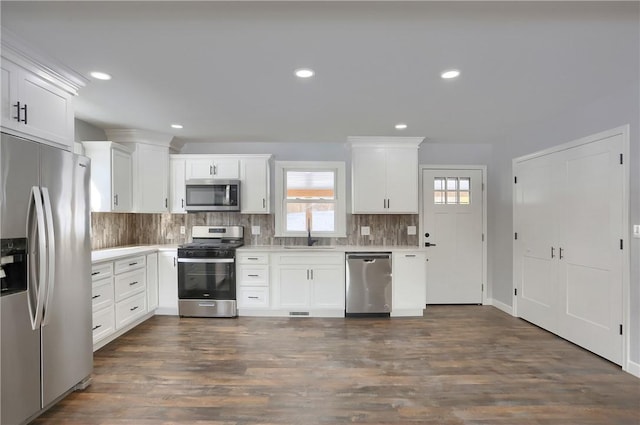 kitchen featuring stainless steel appliances, a healthy amount of sunlight, white cabinetry, and sink