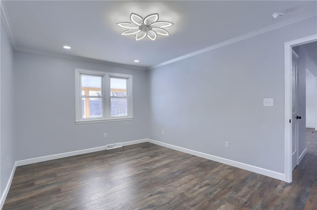 empty room with dark hardwood / wood-style flooring and ornamental molding