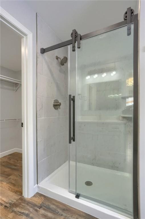 bathroom featuring hardwood / wood-style flooring and walk in shower