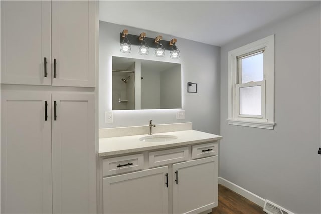 bathroom featuring hardwood / wood-style flooring and vanity