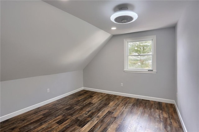 bonus room featuring dark hardwood / wood-style flooring and vaulted ceiling