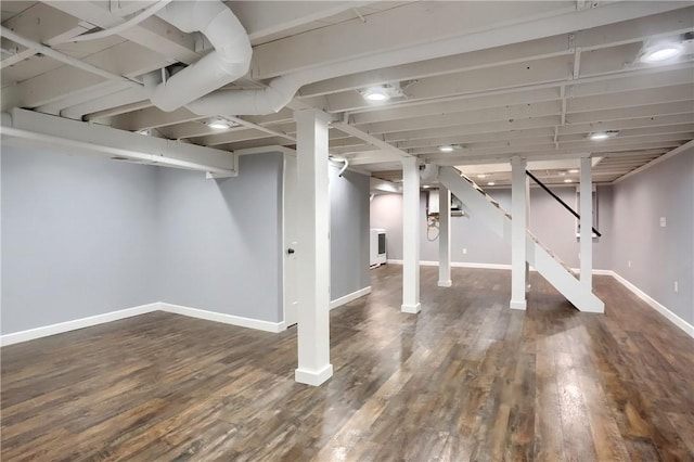 basement with dark hardwood / wood-style floors