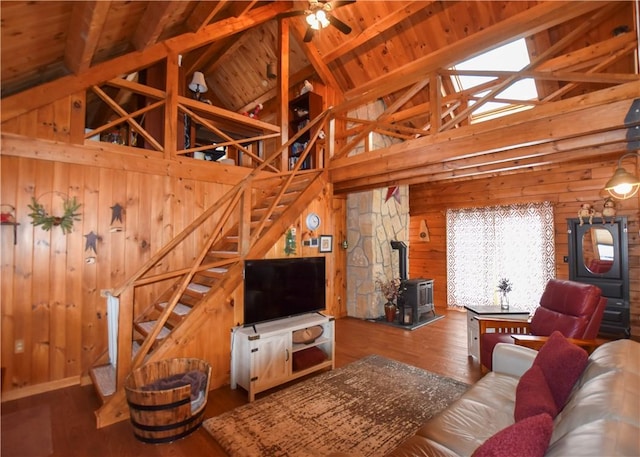 living room with wood ceiling, a wood stove, wood-type flooring, high vaulted ceiling, and beamed ceiling