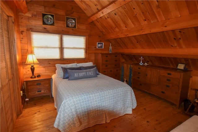 bedroom with vaulted ceiling with beams, wood ceiling, wood walls, and light hardwood / wood-style flooring