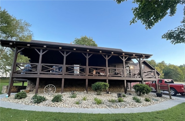 rear view of house featuring a wooden deck