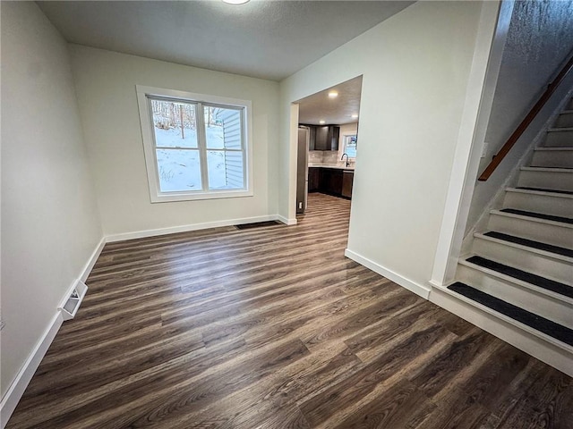 empty room featuring dark hardwood / wood-style flooring