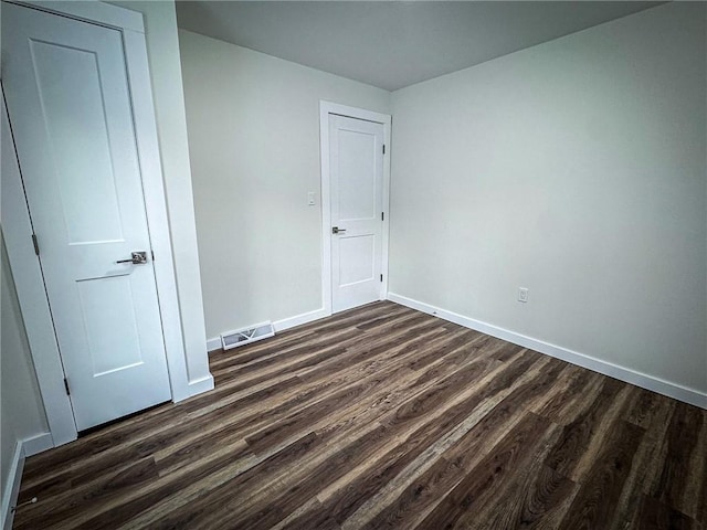 spare room with dark hardwood / wood-style flooring