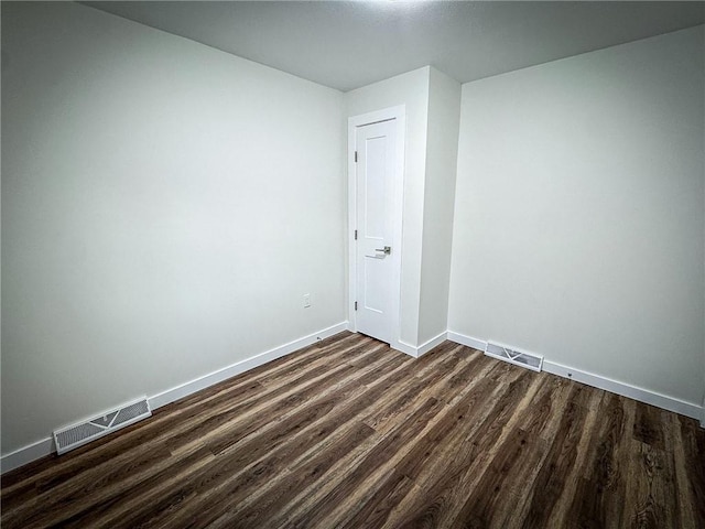 unfurnished room featuring dark hardwood / wood-style floors