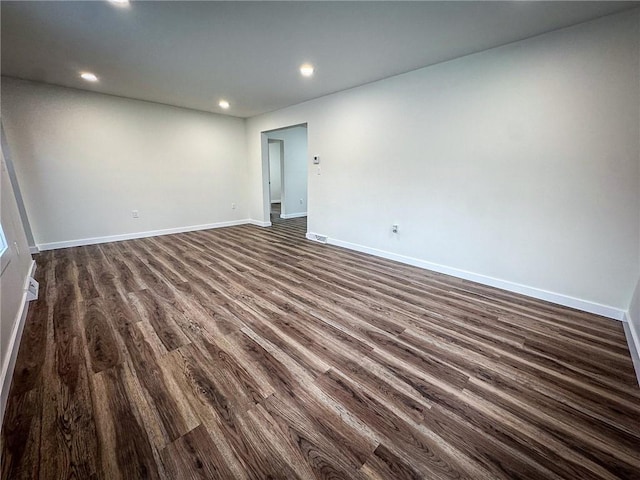 empty room featuring dark wood-type flooring