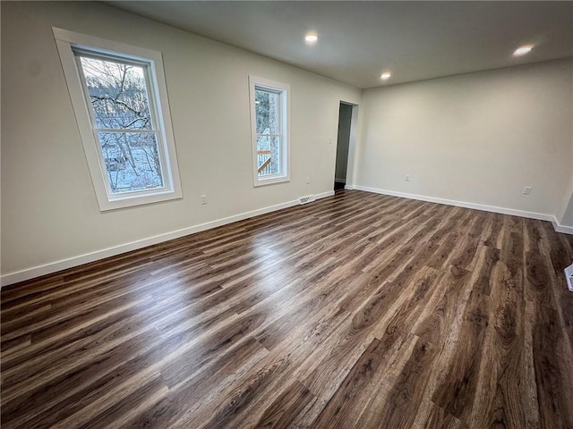 empty room featuring dark wood-type flooring