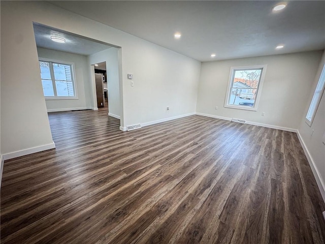 spare room featuring dark wood-type flooring