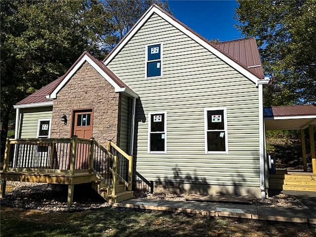 back of property with a wooden deck