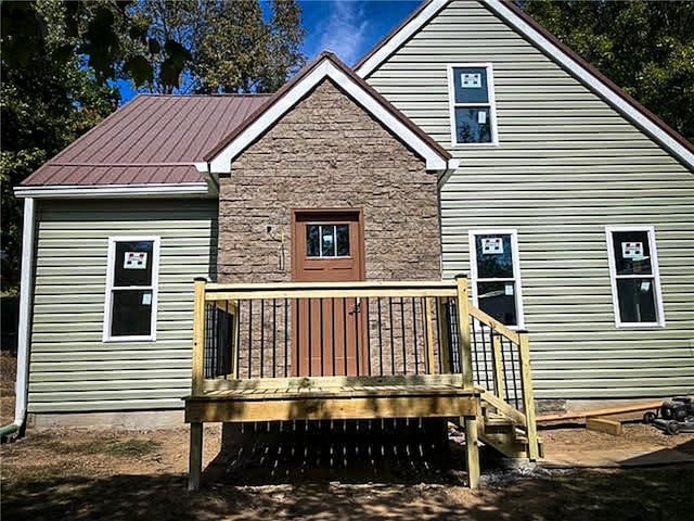 back of property with a wooden deck