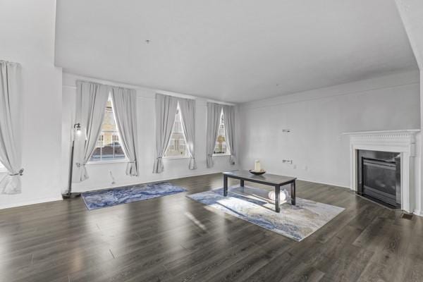 unfurnished living room featuring dark hardwood / wood-style floors