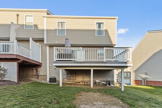 rear view of house with central AC unit, a deck, and a lawn